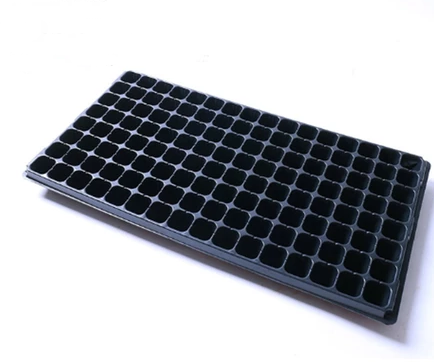 Black plastic seedling tray on a white background