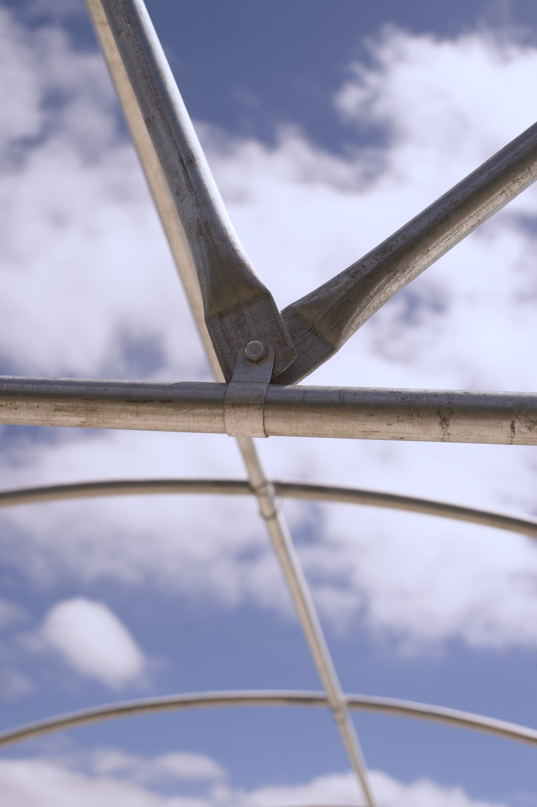 Metallic structure against a cloudy sky