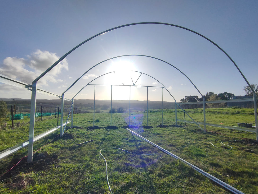 Galvanised Steel Pipes structure on a grassy field with a clear sky