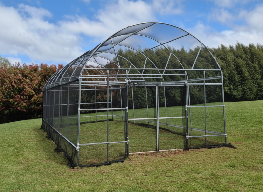 Net house structure on a grassy area with trees in the background
