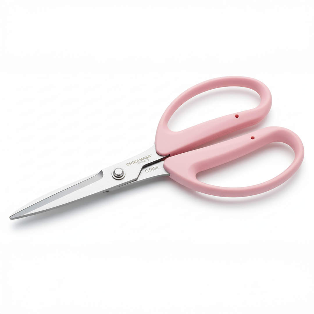 Pink scissors with silver blades on a white background