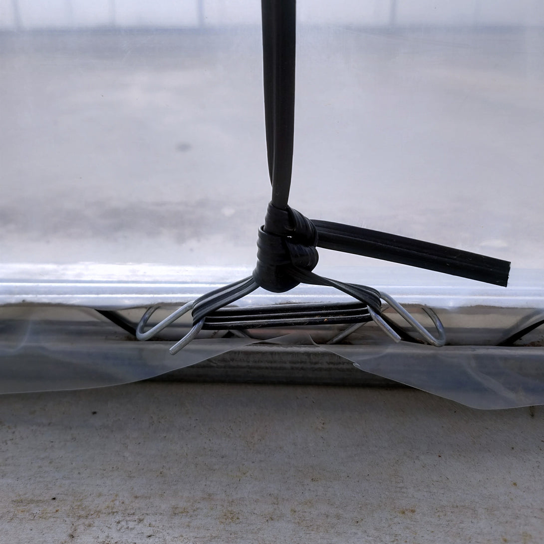 Close-up of a  plastic tie rop with a black cord clips on a transparent plastic background.
